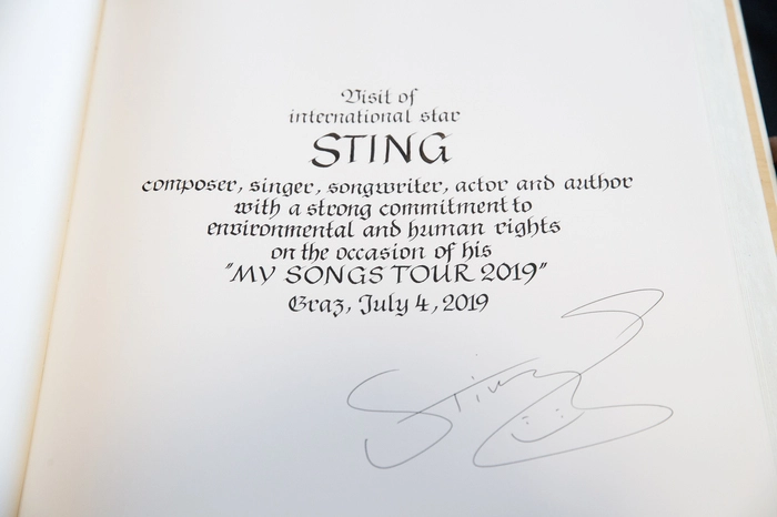 Sting trug sich mit seinem Namen und einem Smiley ins Buch ein- “Besuch des internationalen Stars Sting, Komponist, Sänger, Songwriter, Schauspieler und Autor mit starkem Einsatz für Umweltschutz und Menschenrechte, aus Anlass seiner “My Songs Tour 2019” steht da in ehrwürdig kunstvoller Handschrift geschrieben