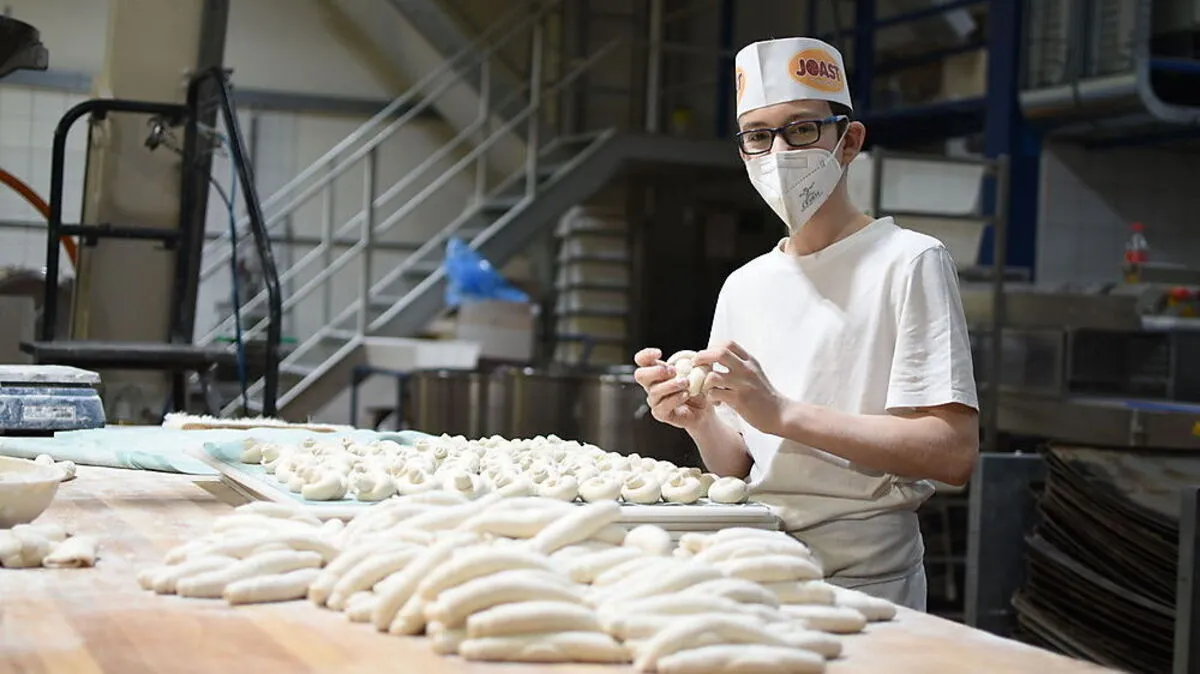 Florian Dullnig formt mit gekonnten Handgriffen in Windeseile die Laugenjourgebäckknöpfe