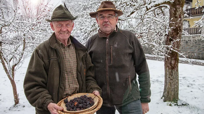 Franz Rauter (links) und der Obmann des Steuerberger Kulturverein, Josef Rainer mit einem Korb voller Dörr-Birnen.