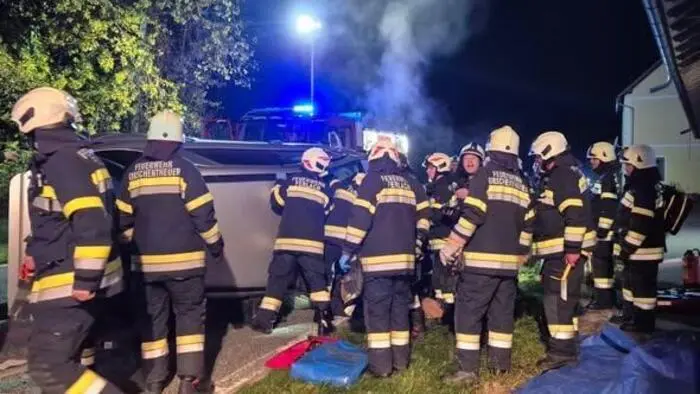 Feuerwehrleute vor Unfallwrack