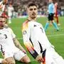 Germany's forward #07 Kai Havertz celebrates with teammates after scoring his team's first goal from the penalty spot during the UEFA Euro 2024 round of 16 football match between Germany and Denmark at the BVB Stadion Dortmund in Dortmund on June 29, 2024. (Photo by KENZO TRIBOUILLARD / AFP)