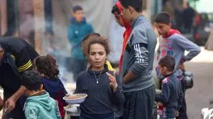 Palestinians line up for food in Rafah, on the southern Gaza Strip on February 7, 2024, amid ongoing battles between Israel and the militant Hamas group. (Photo by Mohammed ABED / AFP)