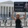 FILE - Nicky Sundt, of Washington, holds a sign with an image depicting Medusa that says, "Remember in November, Vote!," outside of the Supreme Court, June 29, 2022, in Washington. Democrats are pumping an unprecedented amount of money into advertising related to abortion rights, underscoring how central the message is to the party in the final weeks before the November midterm elections. (AP Photo/Jacquelyn Martin, File)