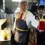 Republican presidential nominee former President Donald Trump, left, hands off an order of fries after working alongside an employee during a visit to McDonald's in Feasterville-Trevose, Pa., Sunday, Oct. 20, 2024. (Doug Mills/The New York Times via AP, Pool)