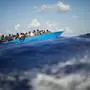 FILE - Migrants sail a wooden boat at south of the Italian Lampedusa island at the Mediterranean sea, Aug. 11, 2022. The back-to-back shipwrecks of migrant boats off Greece that left at least 22 people dead this week has once again put the spotlight on the dangers of the Mediterranean migration route to Europe. (AP Photo/Francisco Seco, file)