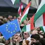 Protesters display the Hungarian and the European flag as they take part in a rally organised by Hungarian opposition figure Peter Magyar, Hungarian lawyer, former government insider and ex-husband of former Justice Minister Varga, in downtown Budapest on April 06, 2024, to denounce the Hungarian government and corruption. (Photo by Attila KISBENEDEK / AFP)