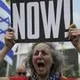 A woman holds a banner and shouts slogans with families and supporters of Israeli hostages held by Hamas in Gaza during a protest calling for their return, outside a meeting between U.S. Secretary of State Antony Blinken and families of hostages in Tel Aviv, Israel, Wednesday, May 1, 2024. (AP Photo/Oded Balilty)