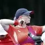 Britain's Jodie Grinham releases an arrow during the Paralympic Games in Paris on Thursday, Aug. 29, 2024. The British archer is competing while pregnant. (AP Photo/Felix Scheyer)