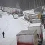 TOPSHOT - A large number of trucks are stuck on the E22 highway at Linderöd in southern Sweden on January 4, 2024, where up to 1,000 cars were stuck in queues since the day before due to large amounts of snow that had fallen on the roadway and restricted access, according to the police. (Photo by Johan Nilsson/TT / TT NEWS AGENCY / AFP) / Sweden OUT