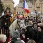 Men dressed as knights ride their horses through a crowd during a demonstration at the Old Town Square in Prague, Czech Republic, Sunday, Jan. 10, 2021. Some thousands of angry protesters have rallied in the Czech capital to protest the government's restrictive measures imposed to contain the coronavirus pandemic. (AP Photo/Petr David Josek)