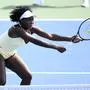Venus Williams reaches for the ball during a doubles match with Hailey Baptiste against Eugenie Bouchard and Clervie Ngounoue at the Citi Open tennis tournament Monday, July 21, 2025, in Washington. (AP Photo/Nick Wass)