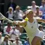 Poland's Iga Swiatek returns to Croatia's Jana Fett in a first round women's singles match on day two of the Wimbledon tennis championships in London, Tuesday, June 28, 2022. (AP Photo/Alberto Pezzali)