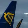 (FILES) In this file photo taken on November 02, 2016 the logo of Irish low-cost airline Ryanair (L) can be seen on a plane standing at the airport in Frankfurt am Main, western Germany. - Germany's Ryanair pilots will join a wave of strikes against the no-frills carrier across Europe on August 10, 2018 escalating a row over pay and conditions at the height of the summer holiday season. (Photo by Andreas Arnold / dpa / AFP) / Germany OUT