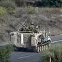 Israeli soldiers ride an armoured vehicle along a road on the outskirts of the southern Israeli city of Sderot on October 28, 2023, amid the ongoing war between Israel and the Palestinian group Hamas. Battles raged in Gaza on October 28, 2023, as Israel's army said it expanded ground operations after intensifying its bombardment of the Palestinian territory three weeks after the deadliest attack in the country's history. (Photo by Aris MESSINIS / AFP)