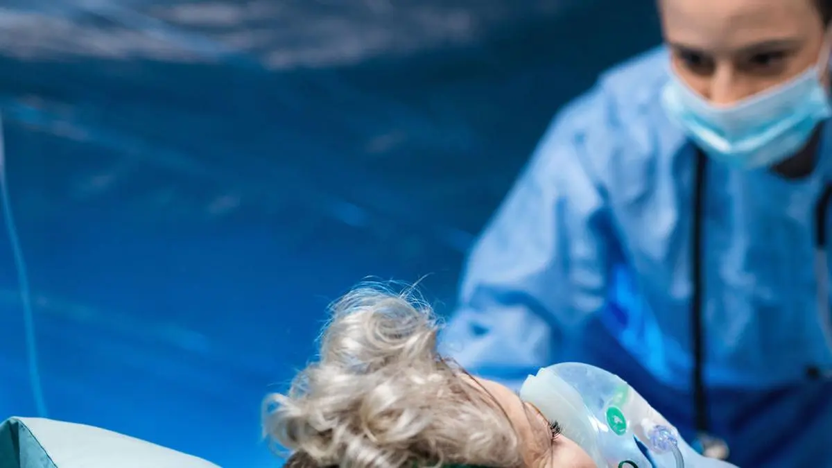 An infected patient in quarantine lying in bed in hospital, coronavirus concept.