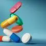 Medical balancing act. A group of medicine pills and antibiotics balacning on top of each other. 3D render illustration.