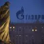 FILE - In this Tuesday, March 4, 2014 file photo, a monument to Ukrainian poet and writer Taras Shevchenko is silhouetted against an apartment building with a sign advertising Russia's natural gas giant Gazprom, in Moscow, Russia. Poland has resumed deliveries of gas to Ukraine that it had halted after its own supplies from Russia dropped this week, the state pipeline operator said Friday, Sept. 12, 2014. The statement by Gaz-System S.A. suggests gas flows from Russian supplier Gazprom are once again meeting Poland's daily demand. State gas company, PGNiG, said that on Thursday it still registered some deficit compared to the ordered amount, but that the shortfall was lower than on Wednesday, when supplies were 45 percent short of demand. The spat between Poland and Russia came amid concerns that Moscow is ready to use its energy exports as a political weapon over the crisis in Ukraine."We do not treat the situation as a crisis," Zawisza said. "It is just one incident." (AP Photo/Alexander Zemlianichenko, file)