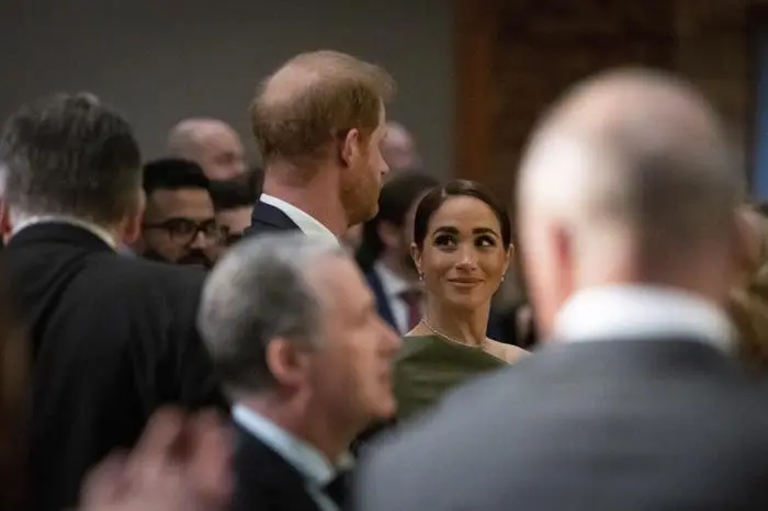 Meghan Markle smiles at Prince Harry during the 