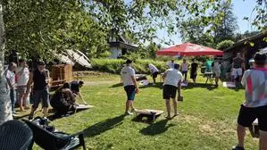 Spielsituation auf einer Wiese, zwei Männer spielen ein Geschicklichkeitsspiel