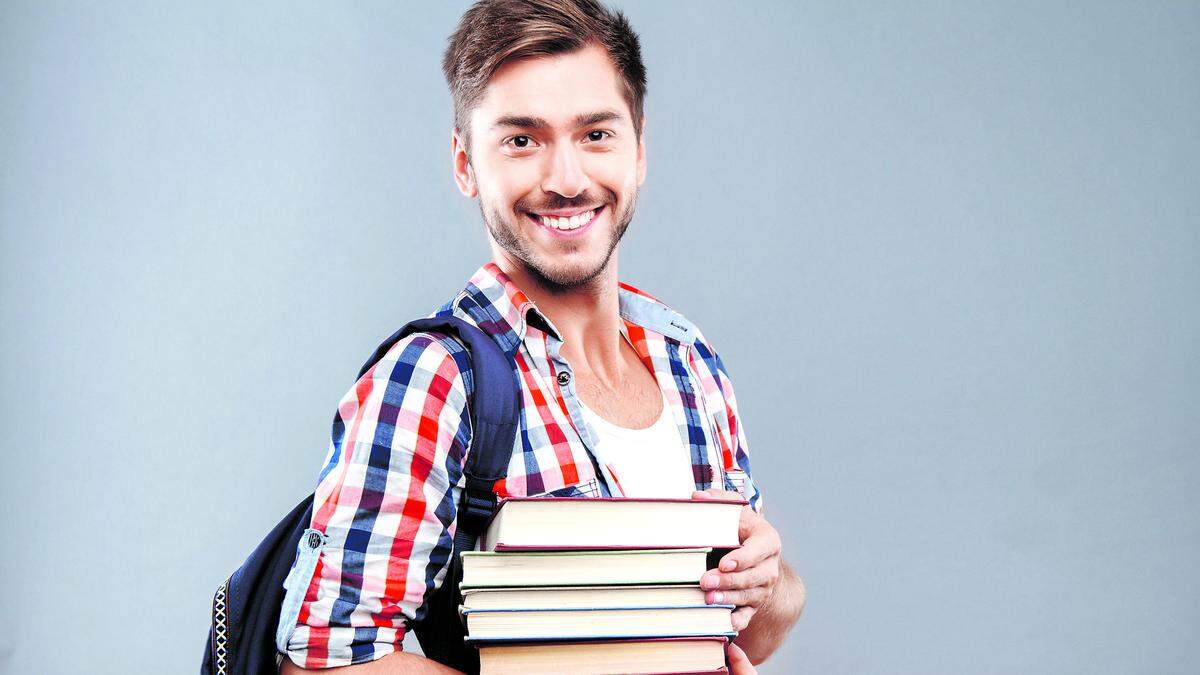 Positive student holding books