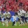 England players celebrate after Trent Alexander-Arnold scored the winning goal during the penalty shootout of a quarterfinal match between England and Switzerland at the Euro 2024 soccer tournament in Duesseldorf, Germany, Saturday, July 6, 2024. (AP Photo/Martin Meissner)