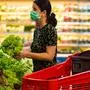 Alarmed female wears medical mask against coronavirus while grocery shopping in supermarket or store- health, safety and pandemic concept - young woman wearing protective medical mask for protection from virus covid-19 and stockpiling food Alarmed female wears medical mask against coronavirus while grocery shopping in supermarket or store- health, safety and pandemic concept - young woman wearing protective medical mask for protection from virus covid-19 and stockpiling food