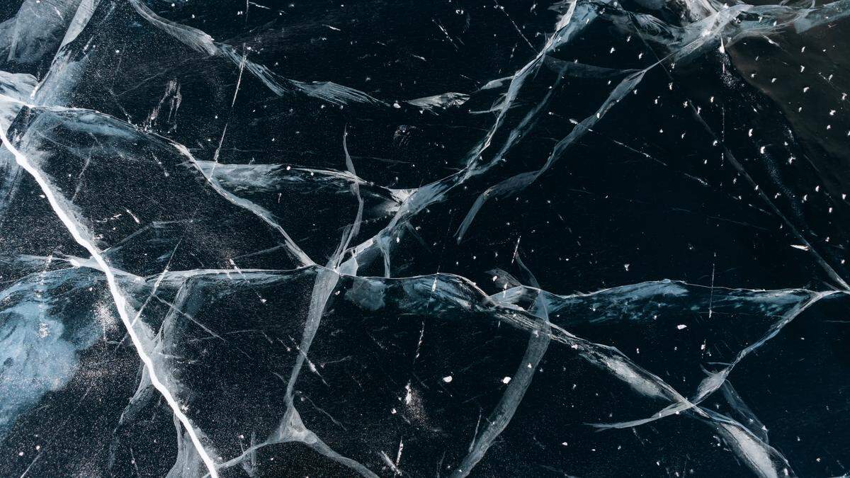 Ice on the Baikal lake. Beautiful cracked ice in winter close-up.