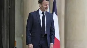 French President Emmanuel Macron smiles after his talks with Senegalese war veterans Friday, April 14, 2023 at the Elysee Palace in Paris. Some of the last survivors in France from a colonial-era infantry corps that recruited tens of thousands of African soldiers to fight in French wars around the world will be able to live out their final days with family members back in Africa after a French government U-turn earlier this year on their pension rights. (AP Photo/Lewis Joly, Pool)