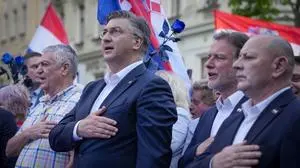 Prime Minister incumbent Andrej Plenkovic, centre, sings the nationals anthem during his party's rally in Zagreb, Croatia, Sunday, April 14, 2024. Croatia this week holds a parliamentary election following a campaign that was marked by heated exchanges between the country's two top officials, creating a political crisis in the Balkan country, a European Union and NATO member state. (AP Photo/Darko Bandic)