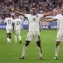 England's midfielder #10 Jude Bellingham celebrates with England's forward #09 Harry Kane after scoring his team's first goal during the UEFA Euro 2024 round of 16 football match between England and Slovakia at the Arena AufSchalke in Gelsenkirchen on June 30, 2024. (Photo by Adrian DENNIS / AFP)
