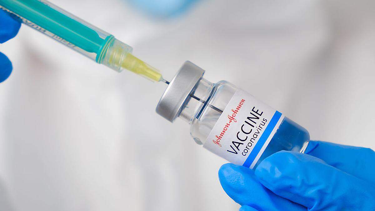 Johnson and johnson coronavirus Vaccine and syringe in the bottle or vial for injection in doctors hands. Covid-19, SARS-Cov-2 prevention, January 2021, San Francisco, USA.