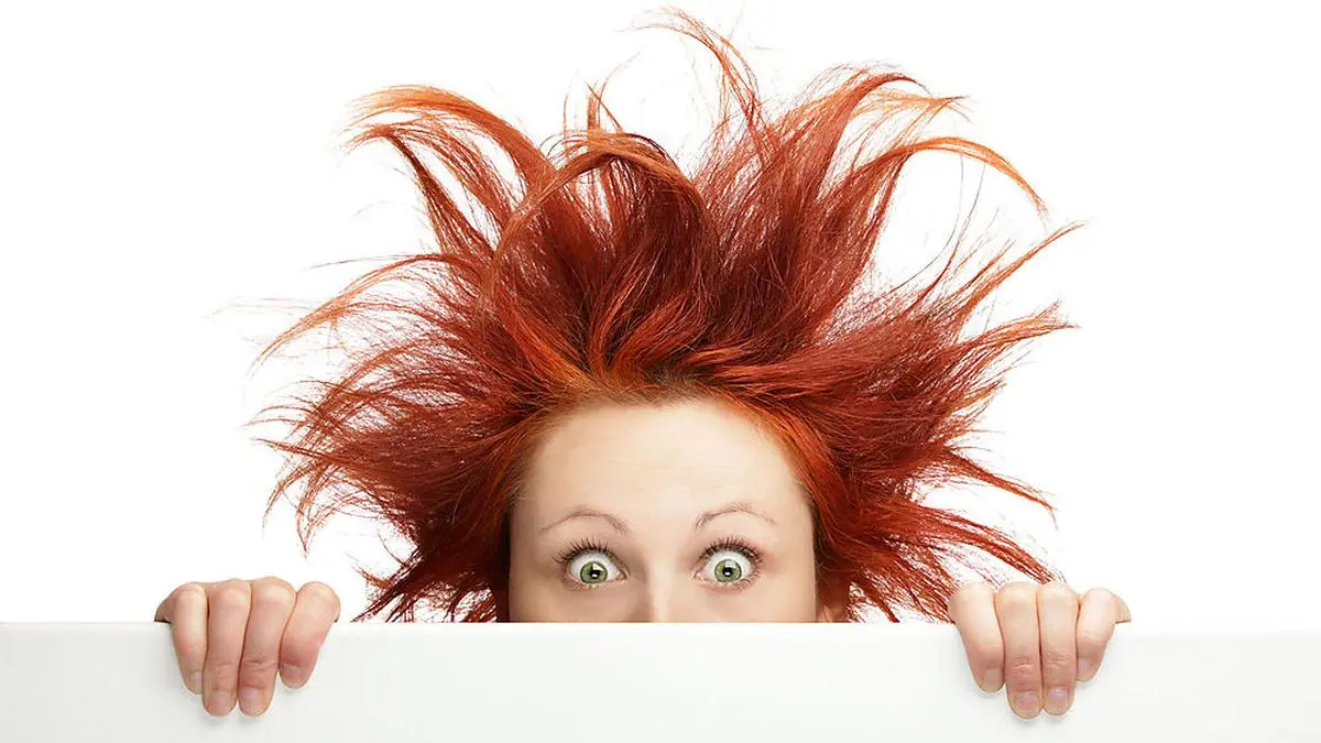Redhead woman with messy hair with copy space