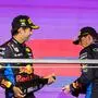 Red Bull Racing's Dutch driver Max Verstappen celebrates winning the Saudi Arabian Formula One Grand Prix alongside second placed Red Bull Racing's Mexican driver Sergio Perez (L) during the podium ceremony at the Jeddah Corniche Circuit in Jeddah on March 9, 2024. (Photo by Giuseppe CACACE / AFP)