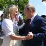 Russian President Vladimir Putin, right, congratulates Austrian Foreign Minister Karin Kneissl as he attends the wedding of Kneissl with Austrian businessman Wolfgang Meilinger in Gamlitz, southern Austria, Saturday, Aug. 18, 2018. (Roland Schlager/pool photo via AP)