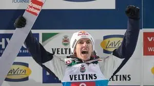Daniel Tschofenig, of Austria, celebrates on the podium after finishing second in the first stage of the Four Hills ski jumping tournament in Oberstdorf, Germany, Monday, Dec. 29, 2025. (AP Photo/Matthias Schrader)