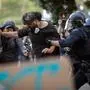 Police in riot gear grab a man during a protest following federal immigration operations in the Little Tokyo neighborhood of Los Angeles on June 9, 2025. President Donald Trump's administration said on June 9 that it was sending 700 US Marines and thousands more National Guard troops to Los Angeles, sparking a furious response from California's governor over the "deranged" deployment. (Photo by RINGO CHIU / AFP)