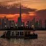 This picture taken from the Dubai Creek Harbour shows the Dubai skyline with Burj Khalifa, the world's largest building (C) as boat sails by on February 5, 2025. (Photo by FADEL SENNA / AFP)