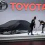 Cleaners operate on the stand of Japanese car maker Toyota ahead of the start of the Geneva International Motor Show 2019 on March 4, 2019 in Geneva. (Photo by Fabrice COFFRINI / AFP)