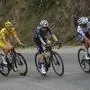 Belgium's Remco Evenepoel, wearing the best young rider's white jersey, Denmark's Jonas Vingegaard and Slovenia's Tadej Pogacar, wearing the overall leader's yellow jersey, climb during the twentieth stage of the Tour de France cycling race over 132.8 kilometers (82.5 miles) with start in Nice and finish in La Couillole pass, France, Saturday, July 20, 2024. (AP Photo/Daniel Cole)