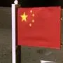 This picture taken and released on December 4, 2020, by the China National Space Administration (CNSA) via CNS shows a Chinese national flag unfurled from the Chang'e-5 lunar probe. - A Chinese space probe has lifted off from the surface of the Moon to return to Earth, an ambitious effort to bring back the first lunar samples in four decades. The Chang'e-5 spacecraft, named after the mythical Chinese Moon goddess, left the Moon at 1510 GMT, on December 3, 2020, said China's space agency. (Photo by - / China National Space Administration (CNSA) via CNS / AFP) / - China OUT / RESTRICTED TO EDITORIAL USE - MANDATORY CREDIT "AFP PHOTO / China National Space Administration" - NO MARKETING - NO ADVERTISING CAMPAIGNS - DISTRIBUTED AS A SERVICE TO CLIENTS