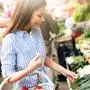 Picture of beautiful woman at marketplace buying vegetables