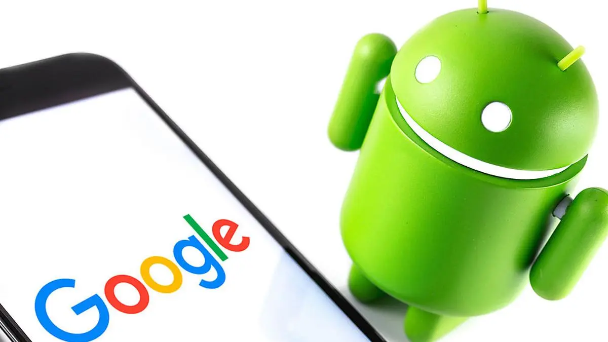closeup Google Android figure and smartphone with Google logo. Google Android is the operating system for smartphones, tablet computers and other devices. Moscow, Russia - March 17, 2019