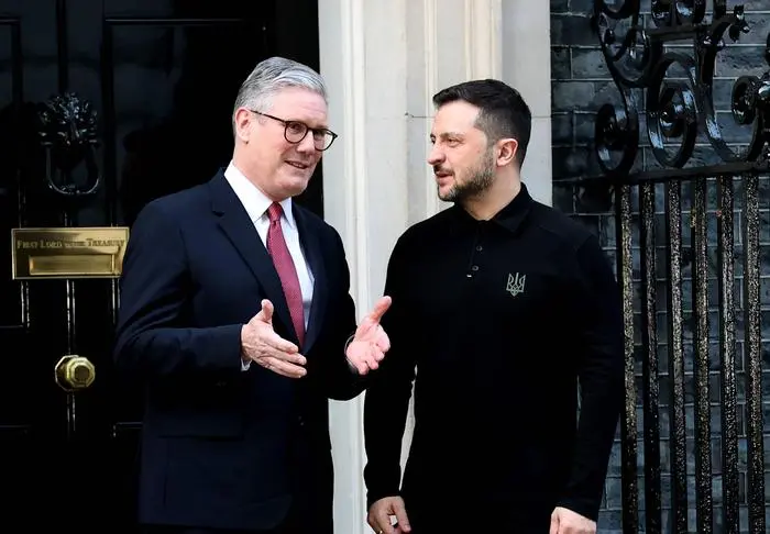 250302 -- LONDON, March 2, 2025 -- British Prime Minister Keir Starmer L speaks with visiting Ukrainian President Volodymyr Zelensky in front of 10 Downing Street in London, Britain, March 1, 2025. Starmer met with visiting Ukrainian President Volodymyr Zelensky on Saturday. During their meeting, Starmer said Ukraine has full backing across the United Kingdom. He stressed Britain s unwavering determination to achieve lasting peace. Britain and Ukraine have agreed a loan of 2.26 billion pounds 2.84 billion U.S. dollars to support Ukraine s defense capabilities, according to Ukrainian Finance Minister Serhiy Marchenko.  BRITAIN-LONDON-STARMER-ZELENSKY-MEETING LixYing PUBLICATIONxNOTxINxCHN