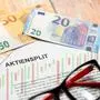25 February 2023: Symbol image shares split - document with inscription: Shares Split together with glasses and euro banknotes. Trading on the stock exchange with securities and shares concept *** Symbolbild Aktien Split - Dokument mit Aufschrift: Aktiensplit zusammen mit einer Brille und Euro Geldscheinen. Handel an der BÃ¶rse mit Wertpapieren und Aktien Konzept