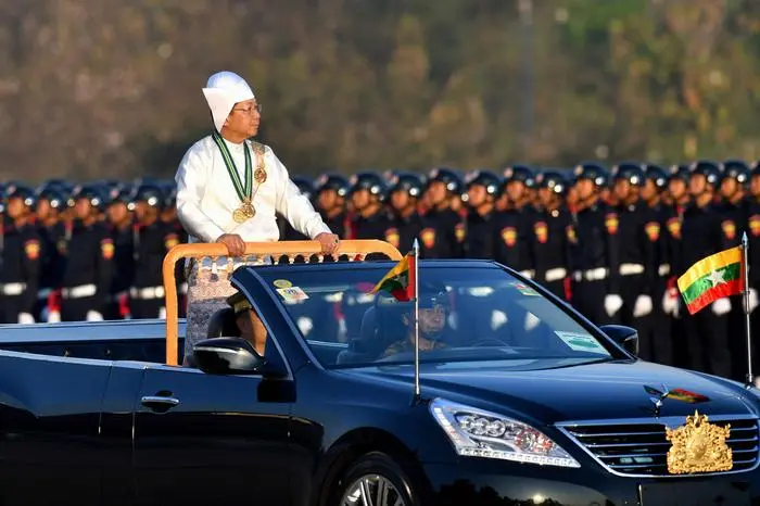 (FILES) Myanmar's military chief Min Aung Hlaing stands in a car as he oversees a military display at a parade ground to mark the country's Independence Day in Naypyidaw on January 4, 2023. Myanmar's junta chief said that the war-torn country would hold an election in December or January, the first since the military staged a 2021 coup. 