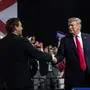 (FILES) US President Donald Trump shakes hands with US Representative Ron DeSantis, Republican of Florida, and candidate for Florida Governor, as he speaks during a campaign rally at Florida State Fairgrounds Expo Hall in Tampa, Florida, on July 31, 2018. Florida Governor and 2024 Republican presidential hopeful Ron DeSantis has dropped out of the US presidential campaign and endorsed former US president Donald Trump, DeSantis announced in a video posted to his X (formerly Twitter) account on January 21, 2024. (Photo by SAUL LOEB / AFP)