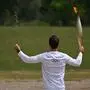 First torch bearer, rowing Olympic gold medalist on 2020, Stephanos Ntouskos, runs with the Olympic torch during the lighting ceremony for the Paris 2024 Olympics Games at the Ancient Olympia archeological site, birthplace of the ancient Olympics in southern Greece, on April 16, 2024. (Photo by Aris MESSINIS / AFP)