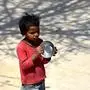 A child holds a bowl as he queues to get free food at a government school during a government-imposed nationwide lockdown as a preventive measure against the spread of the COVID-19 coronavirus in New Delhi on April 3, 2020. (Photo by Money SHARMA / AFP)