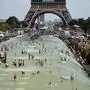 People cool off and sunbathe at the Trocadero Fountains in Paris, on July 25, 2019 as a new heatwave hits the French capital. - After all-time temperature records were smashed in Belgium, Germany and the Netherlands on July 24, Britain and the French capital Paris could on July 25 to see their highest ever temperatures. (Photo by Bertrand GUAY / AFP)