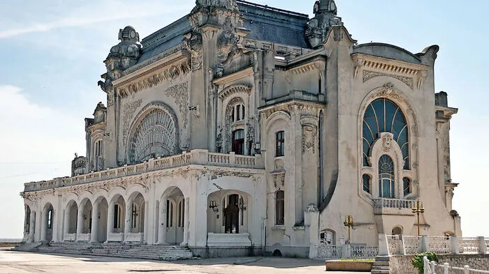 Constanța Casino. Direkt an der Hafenpromenda der rumänischen Stadt Constanța blickt das altehrwürdige und in Würde verfallende Casino aus dem Jahr 1910 auf das Schwarze Meer und in eine glorreiche Vergangenheit.